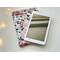 the ebook is on top of kindle pouch on a white table with fairy lights on the left side