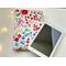 the ebook is sitting on top of the floral kindle cover on a white table with fairy lights on the left side.