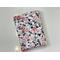 this floral kindle sleeve has a white background with pink flowers and green leaves