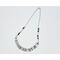 necklace with 1/2" in diameter white and purple shell button style beads, smaller faceted charoite gemstones, and a stainless steel chain 