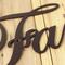 Close up of copper vein powder coat on our metal family sign.