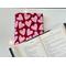 an open book on top of the book jacket on a white table