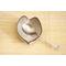 Ceramic heart shaped spoon rest. Glazed in grayish blue and purple colors. Approximately 3"x3.5"