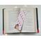 this bookish bookmark is in the middle of an open book with fairy lights around the book on a white table