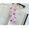 this cute dogs bookmark has a pink background with cute puppies pink hearts and flower along with 'I love you' all over the laminated bookmark.