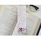 this puppy bookmark has a light pink background  with three dogs and pink flowers at the bottom. there are dog bones, and red and pink hearts falling.