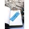 Front of bookmark, light blue background, black handwritten lettering, turtles, starfish, jute rope tassel.