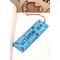 Front of bookmark, light blue background, black handwritten lettering, turtles, starfish, jute rope tassel.