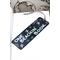Front of bookmark, black background, handwritten lettering in white, starfish, turtles, jute rope tassel.