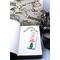 Front of bookmark, white background, red lettering, Christmas Tree and jute rope tassel.
