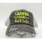 'Camping Hair Don't Care' distressed trucker hat. Neon yellow embroidery on vintage gray mesh. Perfect for adventurous campers