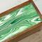 Tea organizer with green and white cover and glossy resin finish.