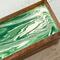 Wooden tea caddy with white and green details.