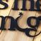 Close up of lettering on our Always Kiss Me Goodnight metal wall decor, in matte black powder coat.