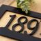 Close up of matte black powder coat for rectangular metal address sign.