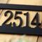 Close up of matte black powder coat on our hanging metal address sign.