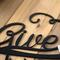 Close up of matte black powder coat on our Give Thanks metal wall art.