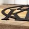 Close up of matte black powder coat on our family name metal sign.