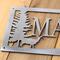Close up of raw steel on our custom family name metal sign with doe deer silhouette.