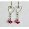 Silver wire shaped into hearts adorned with red crystal Swarovski beads. Great for Valentine's Day or any day.
