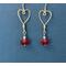 Awaiting Valentine's Day, Argentium silver hearts are on the hook to meet up with cherry red Swarovski beads which dangle below.
