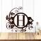 Metal monogram sign with fleur de lis and vines, in copper vein powder coat.