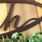 Close up of copper vein powder coat on our metal oval family sign with script font.