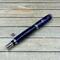 Purple rollerball pen with blue accents 