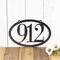 Horizontal oval 3 digit metal house number sign, in silver vein powder coat.