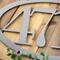 Close up of raw steel on our oval metal house number sign.