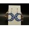 Machine embroidered crescent moon earrings with swirls in the background. Blue swirls on white background with silver hypoallergenic hooks.