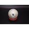 View of bottom of hand painted ornament sitting on little stand.