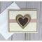 A wedding card with cream embossed cardstock, a tan cardstock mat, a handcrafted burlap heart embellishment and a rose pink ribbon.