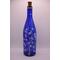 One side of bottle with fairy lights on in low light
