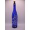 View of alternate side of bottle with fairy lights on in low light.