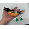 Baltimore Oriole suncatcher being held for size reference.