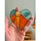 Heart-Sun ornament being held for size reference.