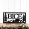 Rectangular metal family name sign with bear and mountains, in matte black powder coat.