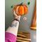 Pumpkin Suncatcher being held for size reference.