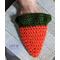 Crocheted carrot pouch with my hand inside to demonstrate that their is a lot of treat space inside.