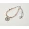 A handcrafted spring-inspired necklace featuring sun hematoid quartz beads, a floral pendant, and a rhodium chain.
