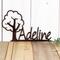 Close up of our boy or girl metal name sign with cute tree silhouette, in copper vein powder coat.
