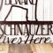 Close up of A Schnauzer Lives Here metal sign, in copper vein powder coat.
