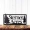 Rectangular metal house name sign with pine trees, in matte black powder coat.