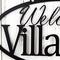Close up of oval welcome to home name metal sign, in matte black powder coat.