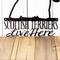 Close up of Scottish Terriers Live Here wording on our metal wall art, in matte black powder coat.
