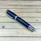 resin cast rollerball pen made with pinecone and blue resin