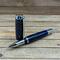 Blue resin and pinecone rollerball pen