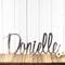 Custom name metal sign with cursive lettering, in raw steel.