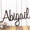 Personalized metal name sign with cursive lettering, in copper vein powder coat.